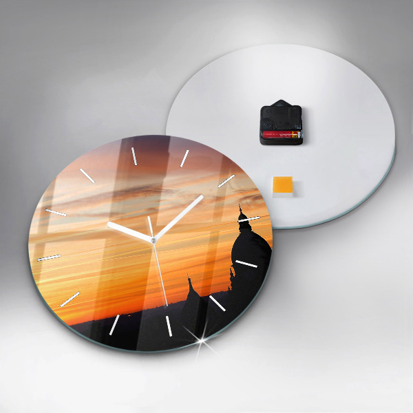Round glass clock Building and sunset