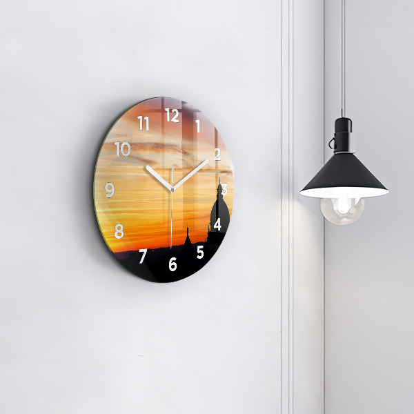 Round glass clock Building and sunset