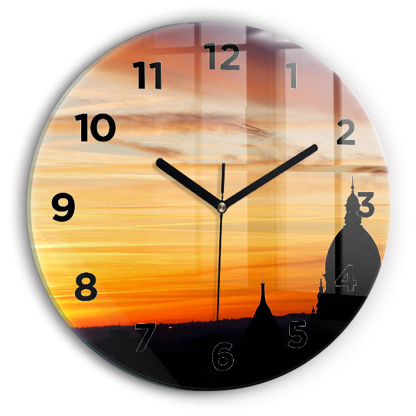 Round glass clock Building and sunset