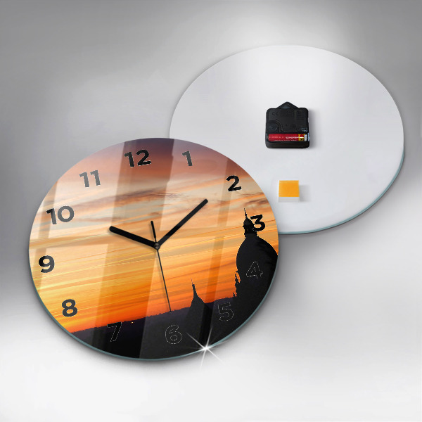 Round glass clock Building and sunset
