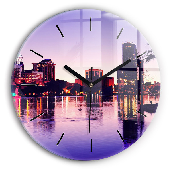 Round glass clock Evening panorama of the city