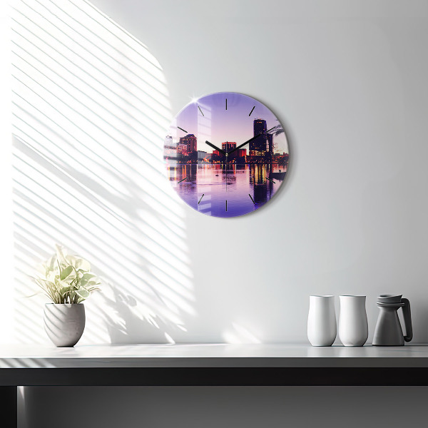 Round glass clock Evening panorama of the city