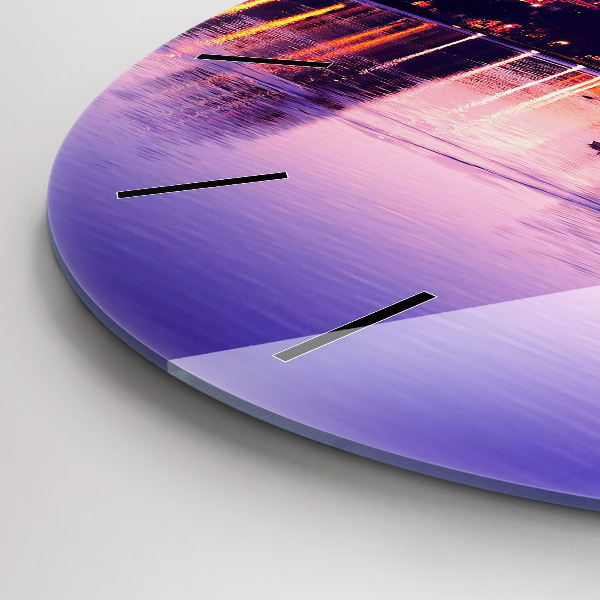 Round glass clock Evening panorama of the city