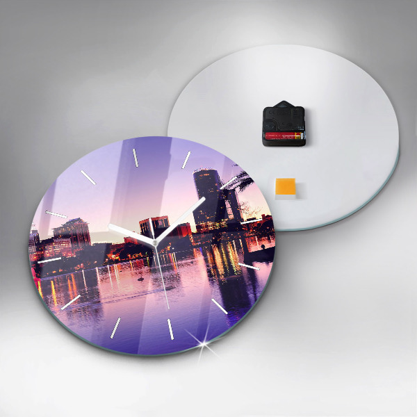 Round glass clock Evening panorama of the city