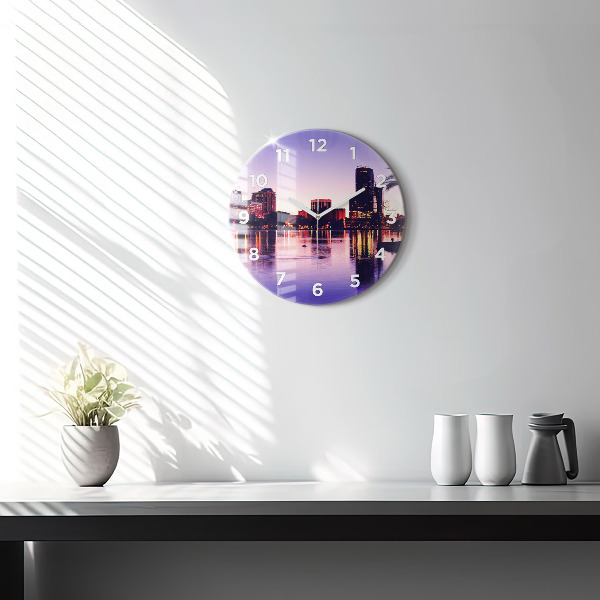 Round glass clock Evening panorama of the city