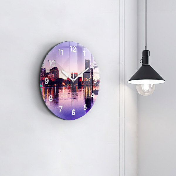 Round glass clock Evening panorama of the city