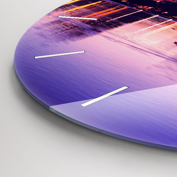 Round glass clock Evening panorama of the city