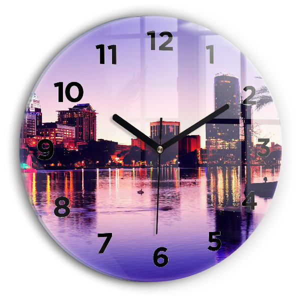 Round glass clock Evening panorama of the city