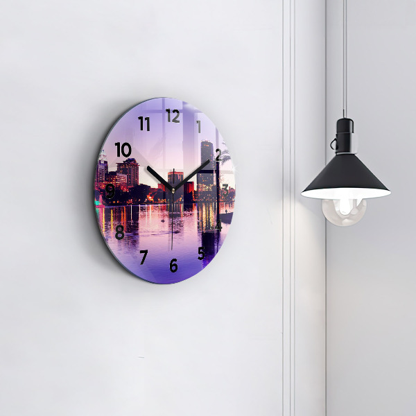 Round glass clock Evening panorama of the city