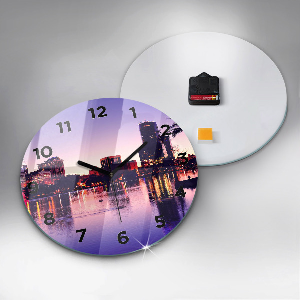 Round glass clock Evening panorama of the city