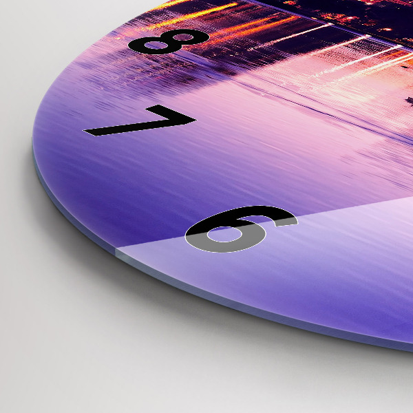 Round glass clock Evening panorama of the city