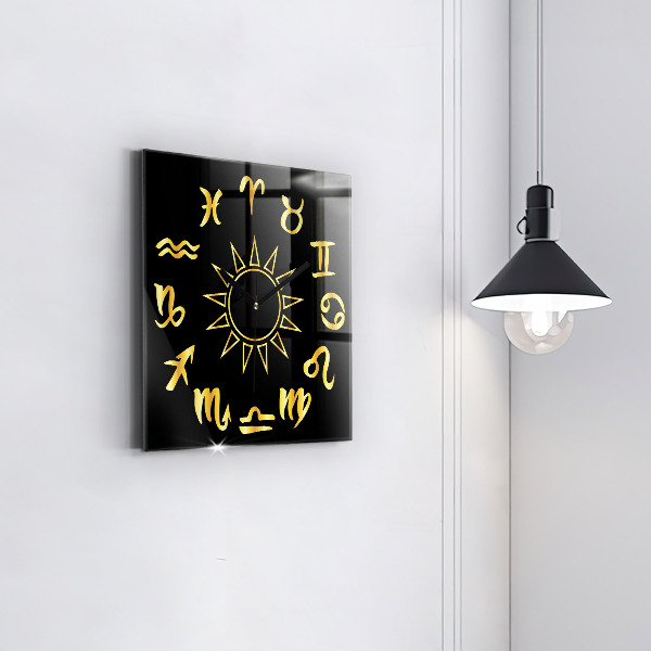 Square glass clock Golden astrological signs on black background